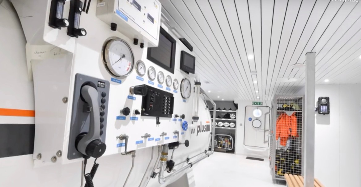 Military hyperbaric chamber interior with advanced control and safety systems