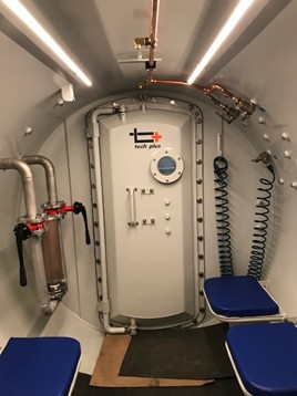 Tunnel worker decompression chamber interior with safety seating for compressed air work